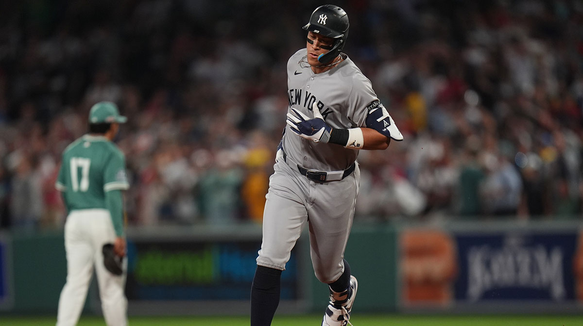 New York Yankees outfielder Aaron Judge (99) hits a home run against the Boston Red Sox in the ninth inning at Fenway Park.