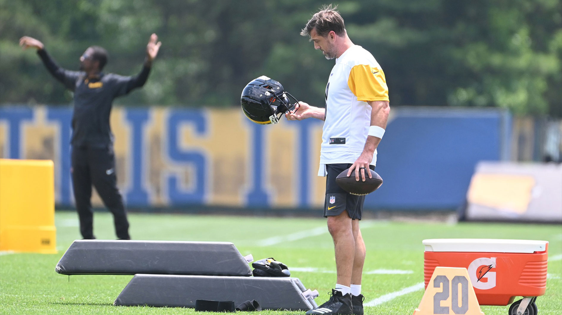 Jun 10, 2025; Pittsburgh, PA, USA; Pittsburgh Steelers quarterback Aaron Rodgers (8) looks over his helmet during minicamp at their South Side facility.