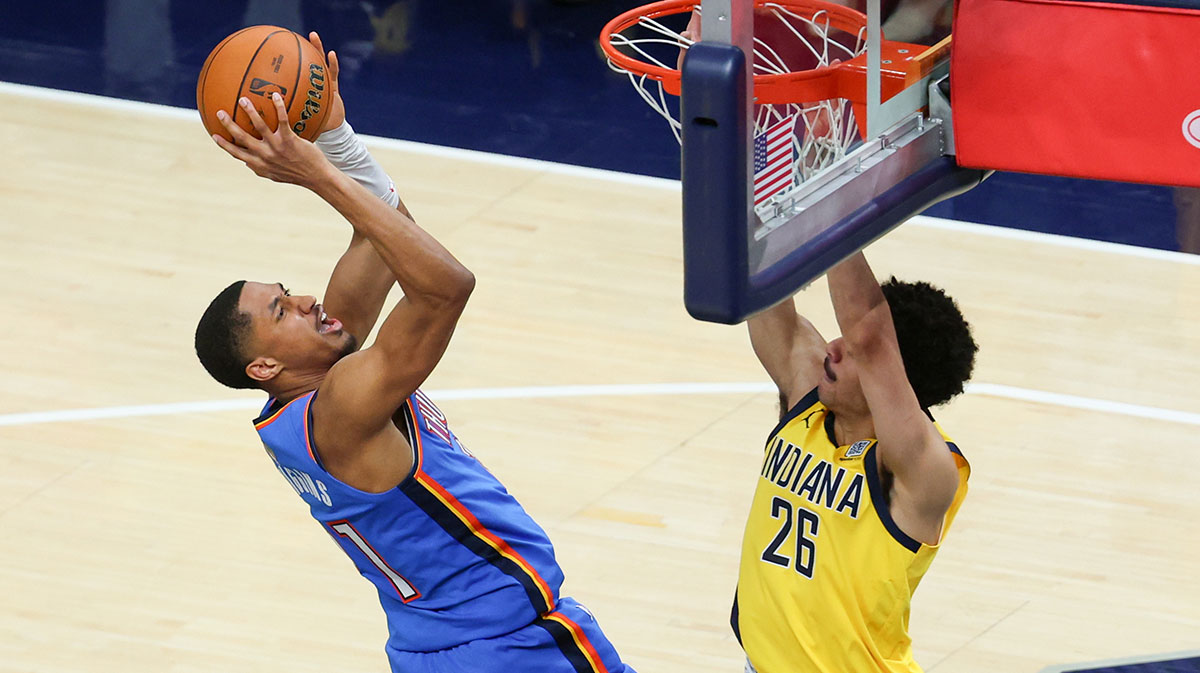 Oklahoma City Thunder guard Aaron Wiggins (21) shoots the ball defended by Indiana Pacers guard Ben Sheppard (26) in the fourth quarter during game six of the 2025 NBA Finals at Gainbridge Fieldhouse.