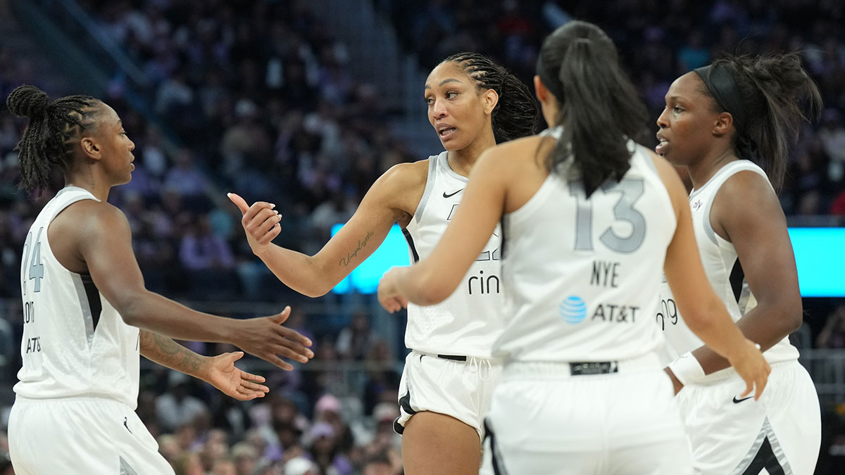 Las Vegas Aces center A'ja Wilson (center left) huddles on the court with guards Jewell Loyd (24) and Chelsea Gray (12) and Aaliyah Nye (13) during the fourth quarter against the Golden State Valkyries at Chase Center.