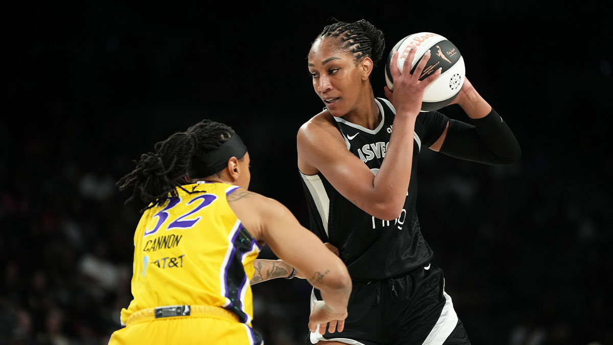 Las Vegas Aces center A'ja Wilson (22) controls the ball against Los Angeles Sparks forward Emma Cannon (32) during the first half of a WNBA basketball game at Michelob Ultra Arena.