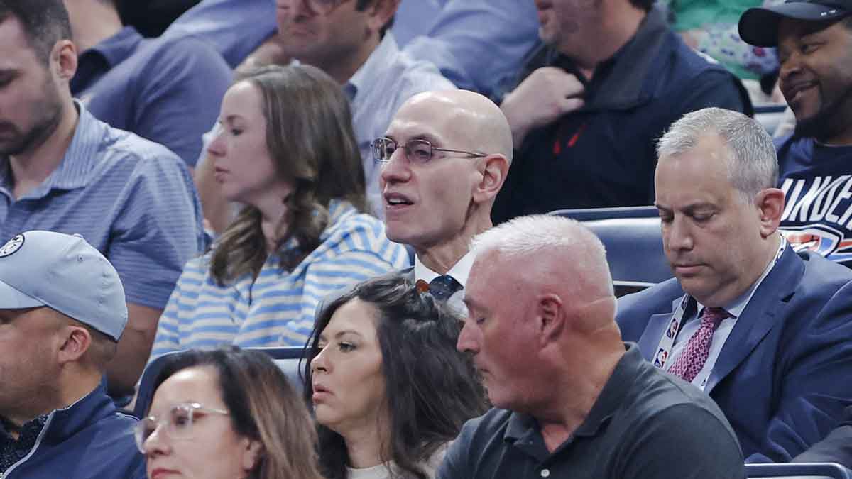 NBA Commissioner Adam Silver, center, watches a game between the Detroit Pistons and Oklahoma City Thunder at Paycom Center.