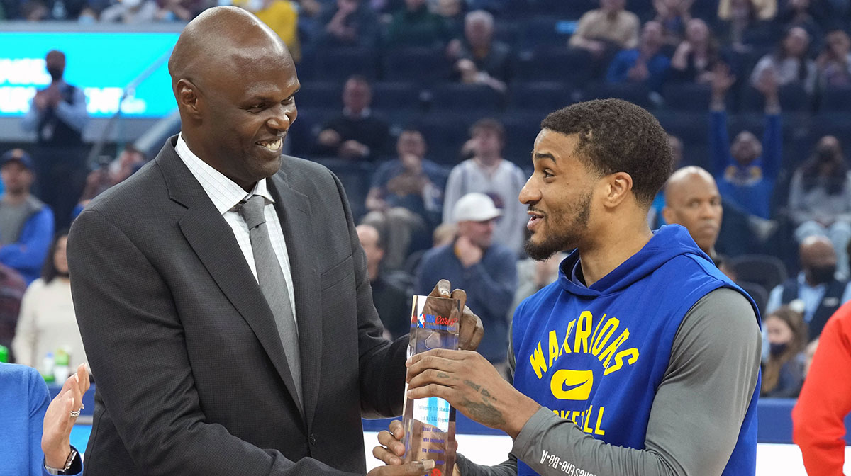 Golden State Warriors guard Gary Payton II (right) receives the NBA Cares Community Assist Award from former player Adonal Foyle before the game against the Milwaukee Bucks at Chase Center.