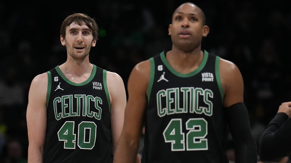 Boston Celtics center Luke Kornet (40) and center Al Horford (42) walk off the court during a time out during the second quarter against the Charlotte Hornets at Spectrum Center.