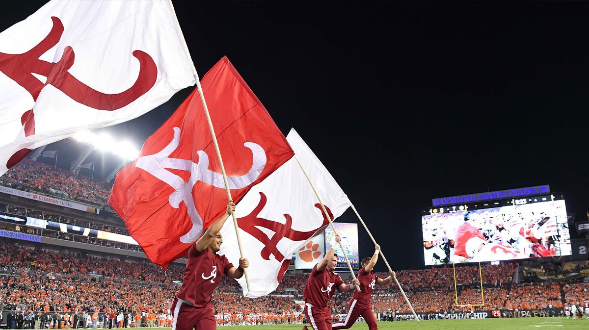 Alabama Crimson Tide cheerleaders run flags in the end zone after a touchdown during the first quarter against the Clemson Tigers in the 2017 College Football Playoff National Championship Game at Raymond James Stadium.