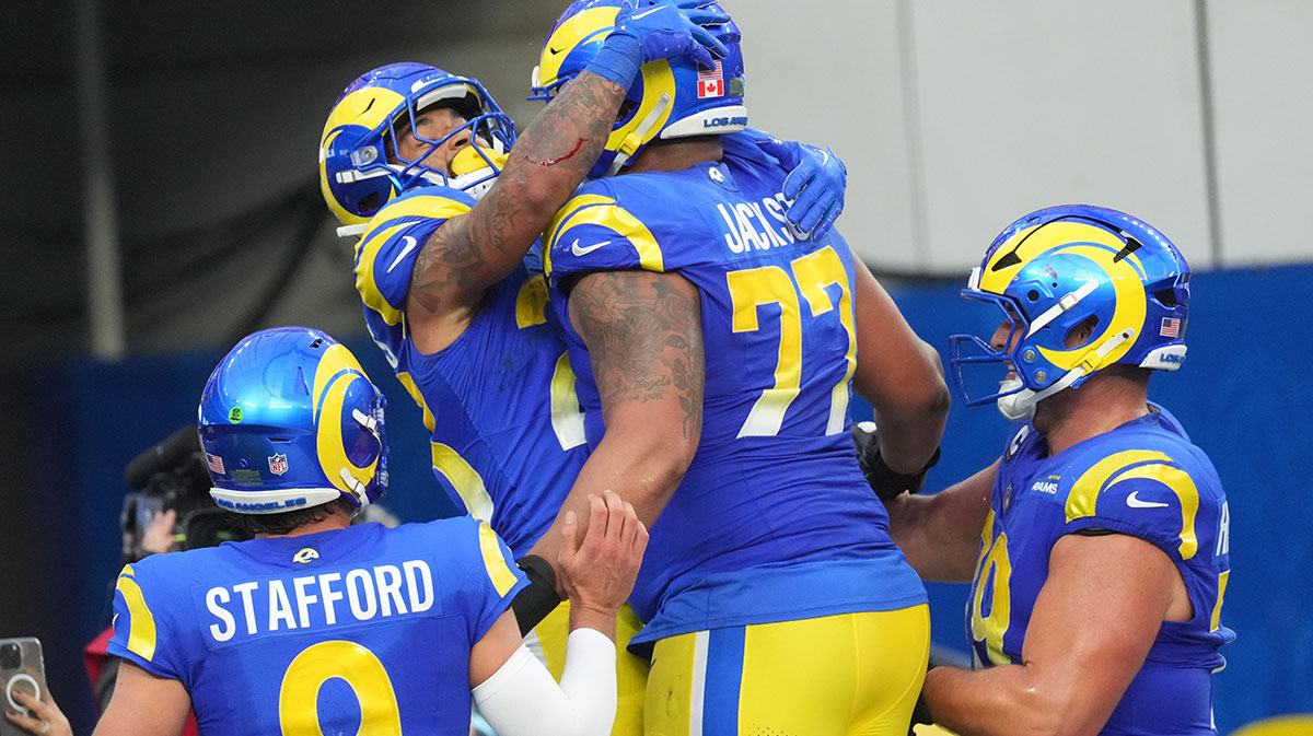 Los Angeles Rams running back Kyren Williams (23) celebrates with quarterback Matthew Stafford (9) and offensive tackle Alaric Jackson (77) after scoring in a 7-yard touchdown run against the Buffalo Bills in the third quarter at SoFi Stadium.