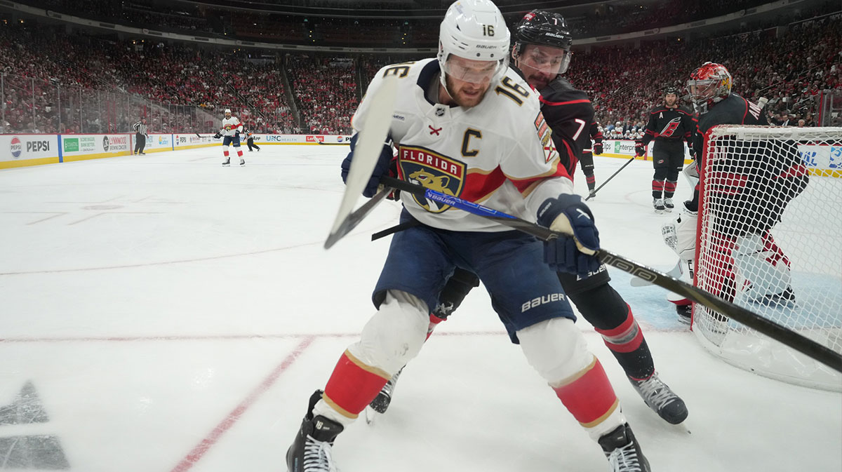 Carolina Hurricanes defenseman Dmitry Orlov (7) battles for the puck against Florida Panthers forward Aleksander Barkov (16) during the first period in game five of the Eastern Conference Final of the 2025 Stanley Cup Playoffs at Lenovo Center.