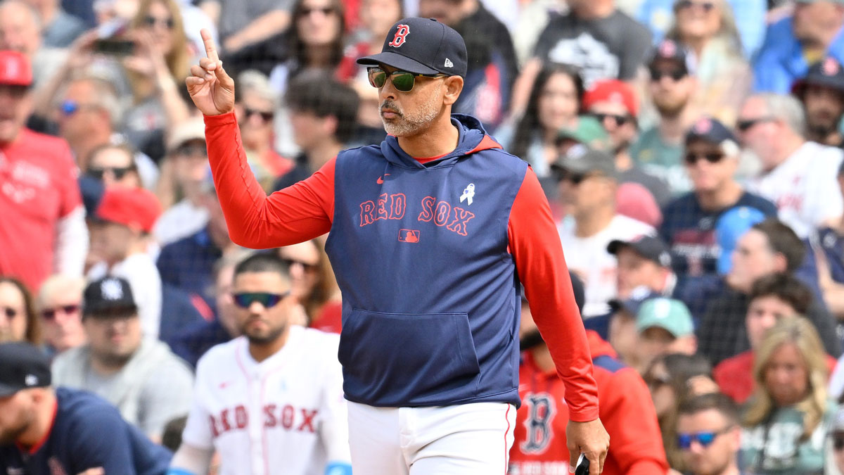 Boston Red Sox manager Alex Cora (13) signals to the bullpen during the eighth inning against the New York Yankees at Fenway Park.