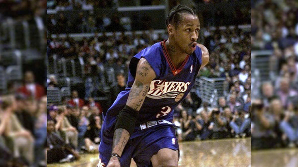 Sixers player Allen Iverson brings the ball up the court.