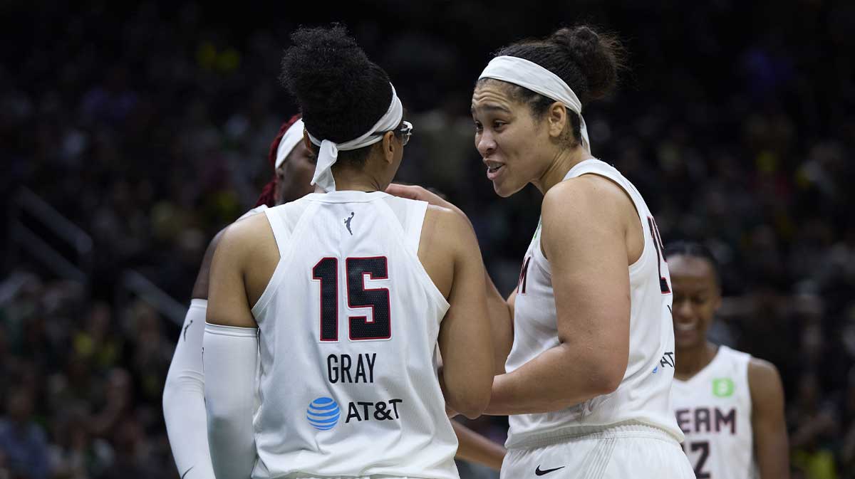 Atlanta Dream guard Allisha Gray (15) talks with Atlanta Dream forward Brionna Jones (24), right, and Atlanta Dream guard Rhyne Howard (10), back left, after a foul call during the second half at Climate Pledge Arena.