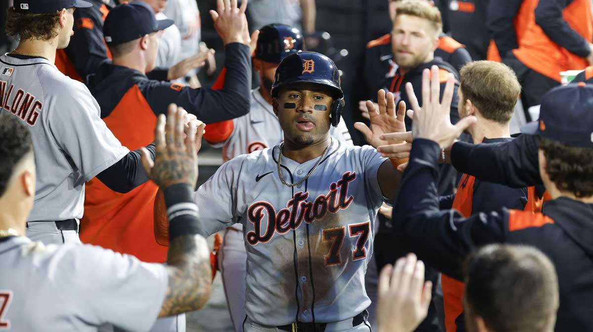 Detroit Tigers third baseman Andy Ibanez (77) celebrates with teammates in the dugout after scoring against the Chicago White Sox during the first inning at Rate Field.