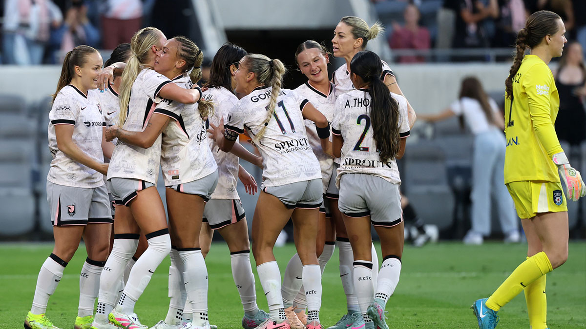 Angel City FC midfielder Kennedy Fuller celebrates with teammates after scoring a goal against Chicago Stars FC goalkeeper Halle Mackiewicz during the first half at BMO Stadium.