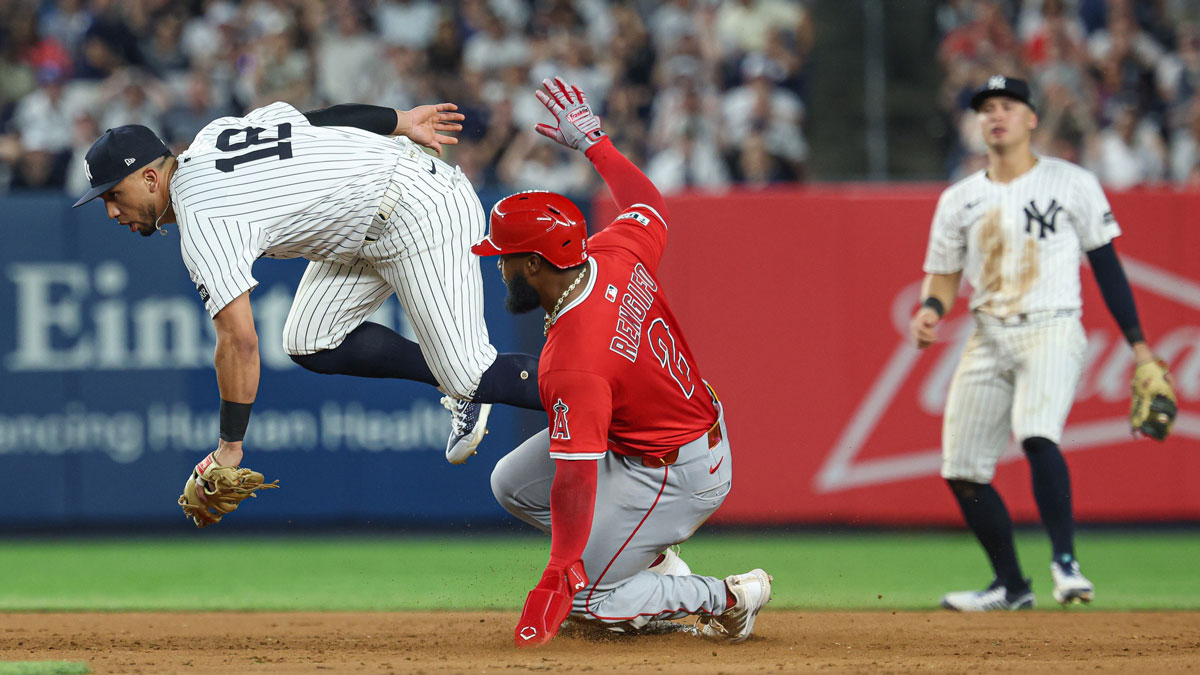 New York Yankees second baseman Oswald Peraza (18) can not handle a throw from shortstop Anthony Volpe (11) as Los Angeles Angels right fielder Luis Rengifo (2) slides safely in to second base on an RBI fielder choice hit by center fielder Jo Adell (not pictured) during the eighth inning at Yankee Stadium.
