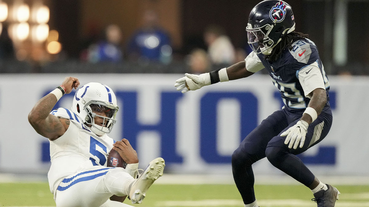 Indianapolis Colts quarterback Anthony Richardson (5) slides to the turf while rushing the ball as Tennessee Titans cornerback Jarvis Brownlee Jr. (29) rushes in during a game against the Tennessee Titans.