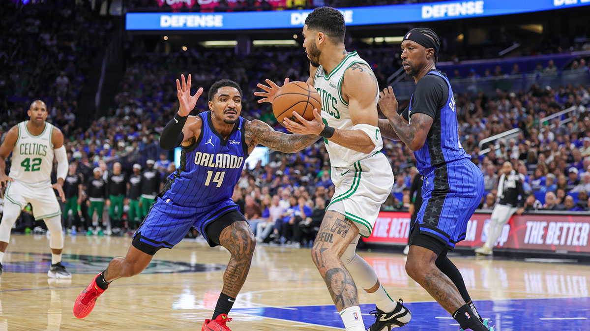 Orlando Magic guard Gary Harris (14) and guard Kentavious Caldwell-Pope (3) defend Boston Celtics forward Jayson Tatum (0) during the second half of game three of first round for the 2024 NBA Playoffs at Kia Center.