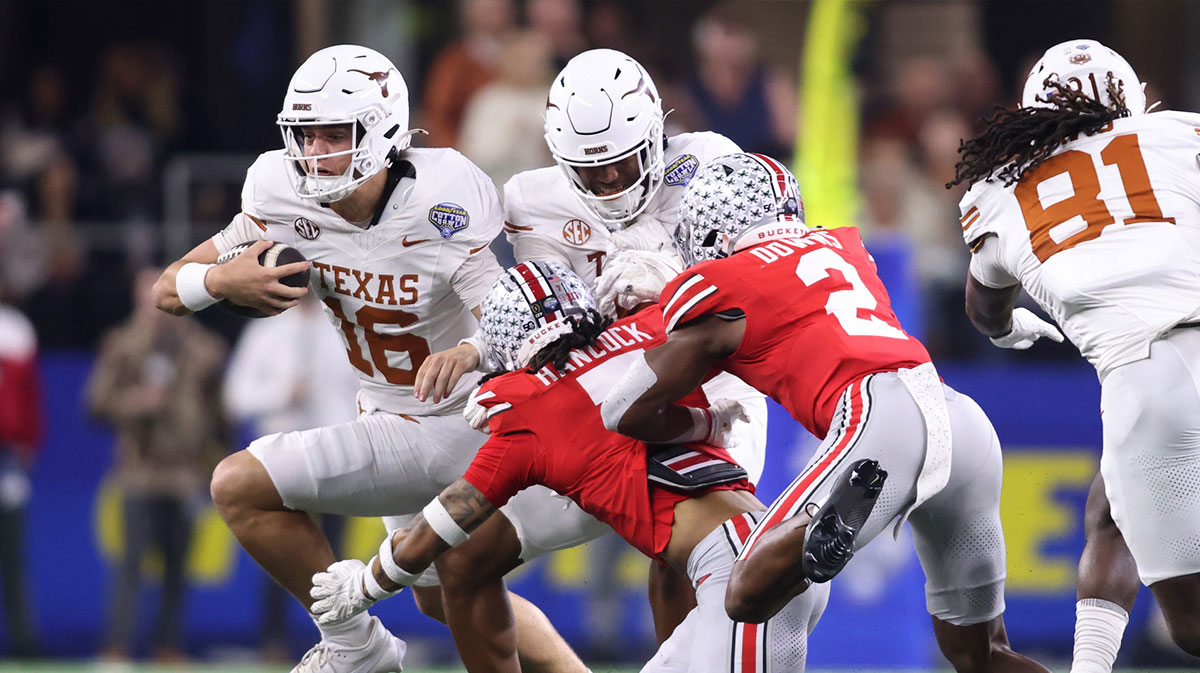 Texas Longhorns quarterback Arch Manning (16) runs against Ohio State Buckeyes cornerback Jordan Hancock (7) and safety Caleb Downs (2) during the second quarter of the College Football Playoff semifinal in the Cotton Bowl at AT&T Stadium. Mandatory Credit: Tim Heitman-Imagn Images