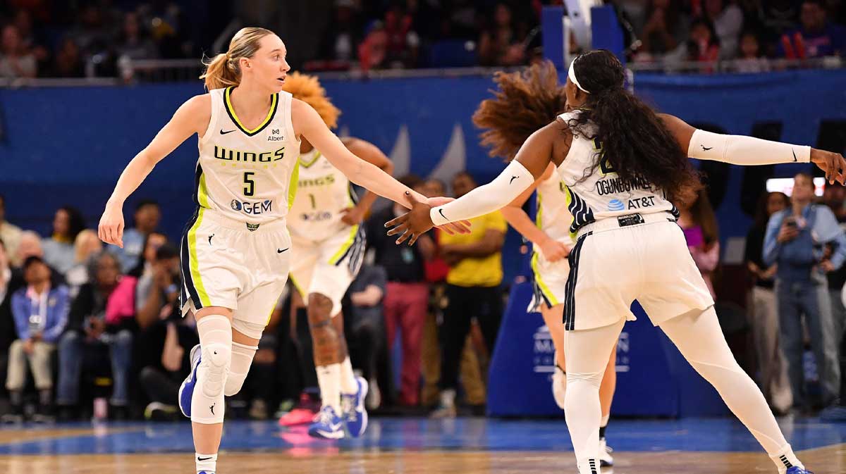 Dallas Wings guard Paige Bueckers (5) celebrates with guard Arike Ogunbowale (24) during the first half against the Chicago Sky at the Wintrust Arena.