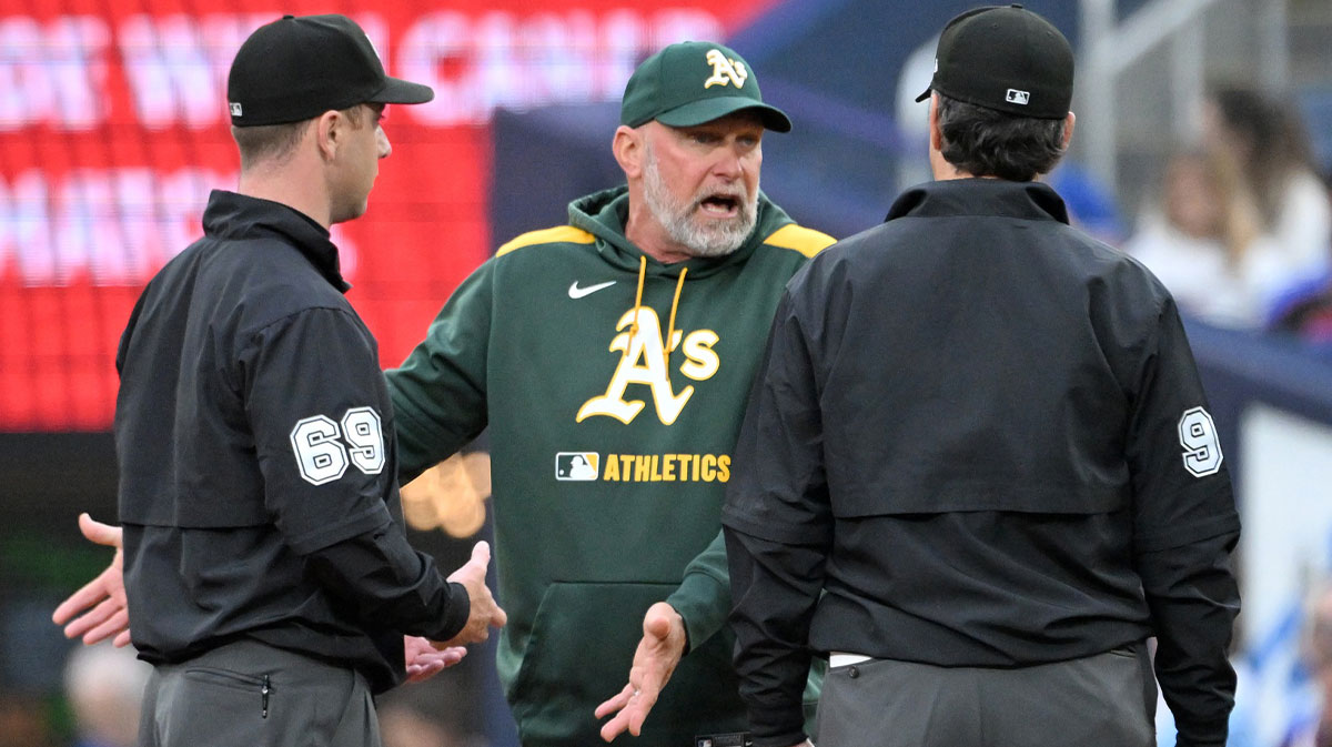 Athletics manager Mark Kotsay (7) speaks to umpires Tom Hanahan (69) and James Hoye (92) after a Toronto Blue Jays double play in the second inning at Rogers Centre.