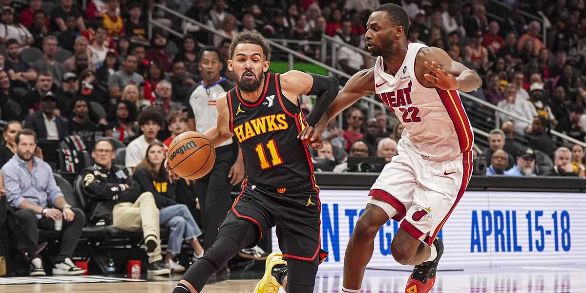 Atlanta Hawks guard Trae Young (11) tries to dribble past Miami Heat forward Andrew Wiggins (22) during the first half at State Farm Arena.