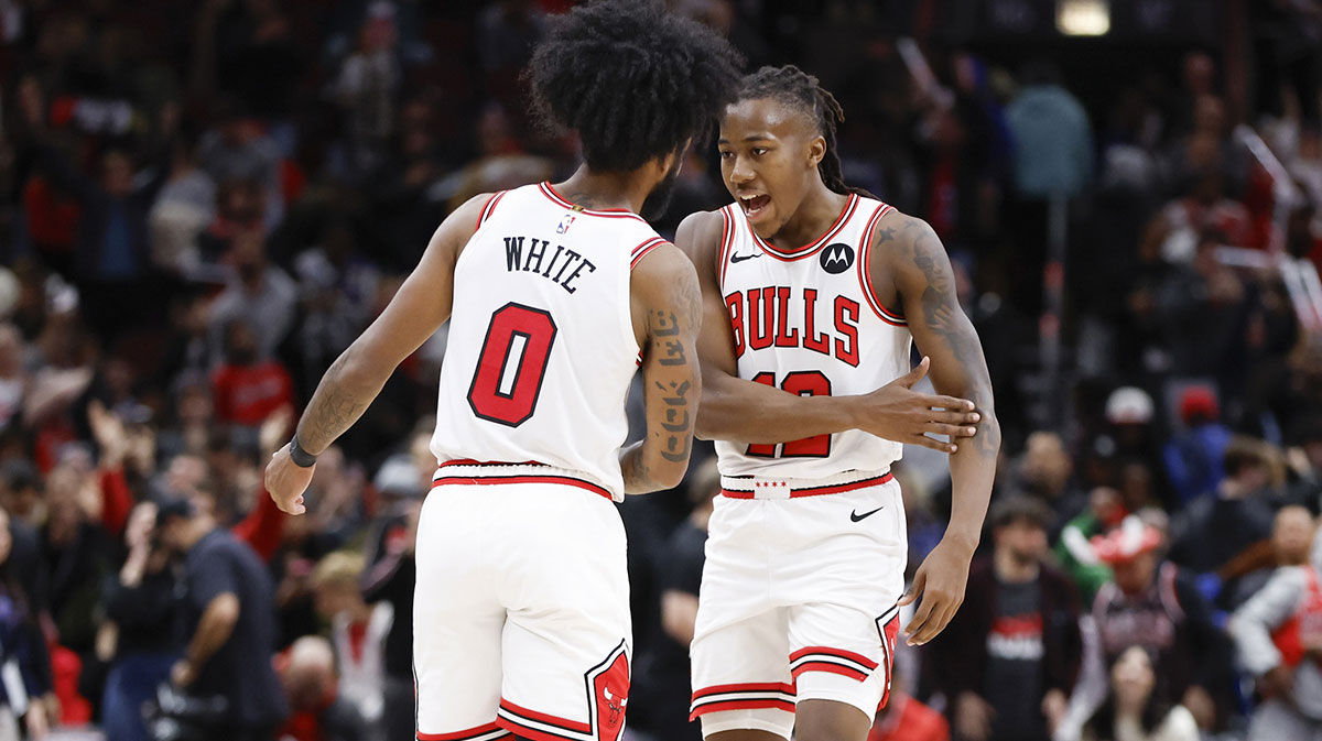 Chicago Bulls guard Coby White (0) celebrates with guard Ayo Dosunmu (12) after defeating the New Orleans Pelicans at United Center.