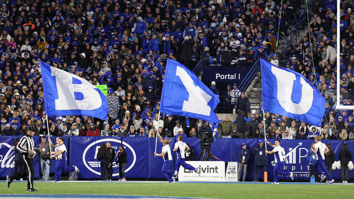 Brigham Young Cougars cheerleaders run with flags after a score against the Oklahoma State Cowboys during the fourth quarter at LaVell Edwards Stadium.