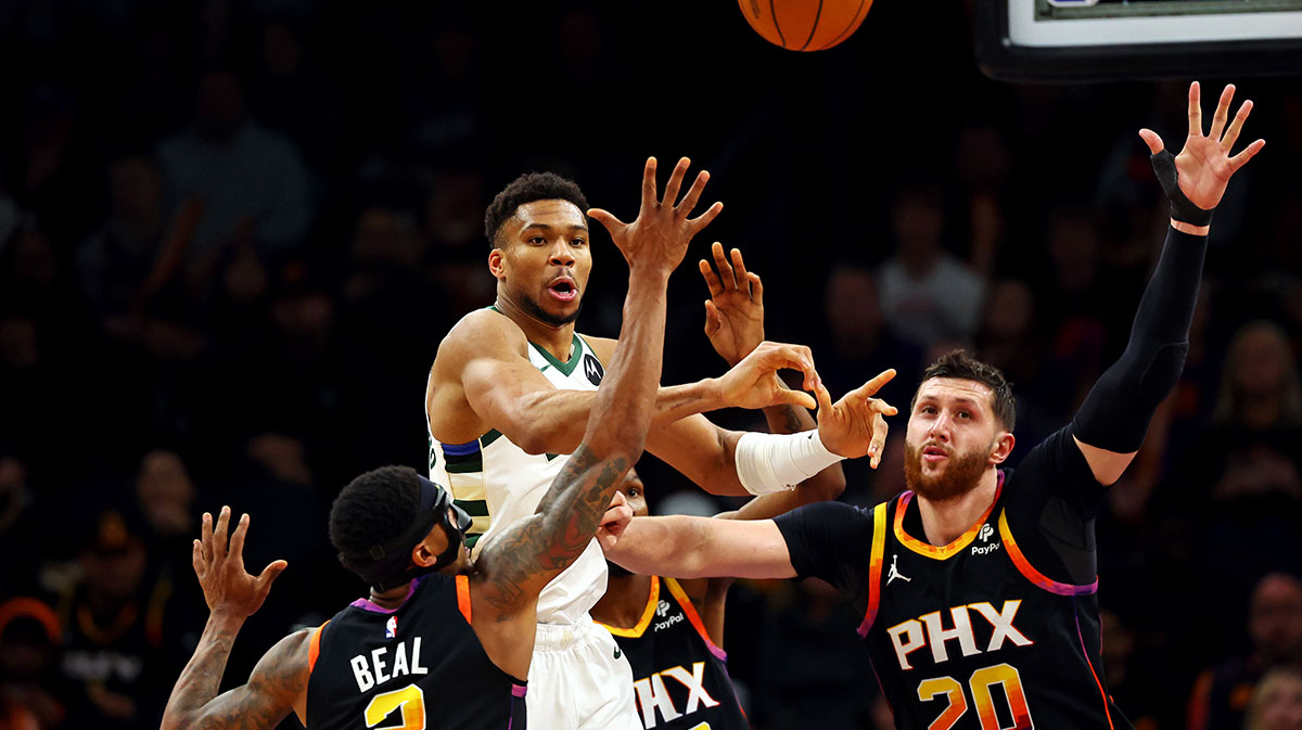 Milwaukee Bucks forward Giannis Antetokounmpo (34) passes the ball against Phoenix Suns guard Bradley Beal (3) and center Jusuf Nurkic (20) during the third quarter at Footprint Center.