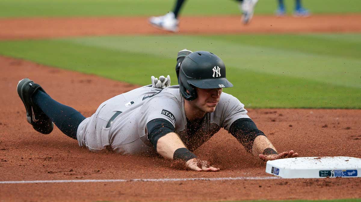 New York Yankees first base Ben Rice (22) dives into third base during the second inning against the Kansas City Royals.