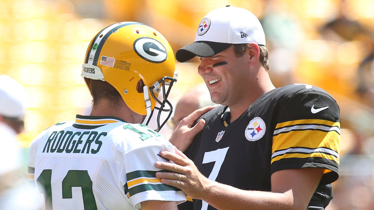 Green Bay Packers quarterback Aaron Rodgers (12) and Pittsburgh Steelers quarterback Ben Roethlisberger (7) talk at mid-field before their game at Heinz Field.