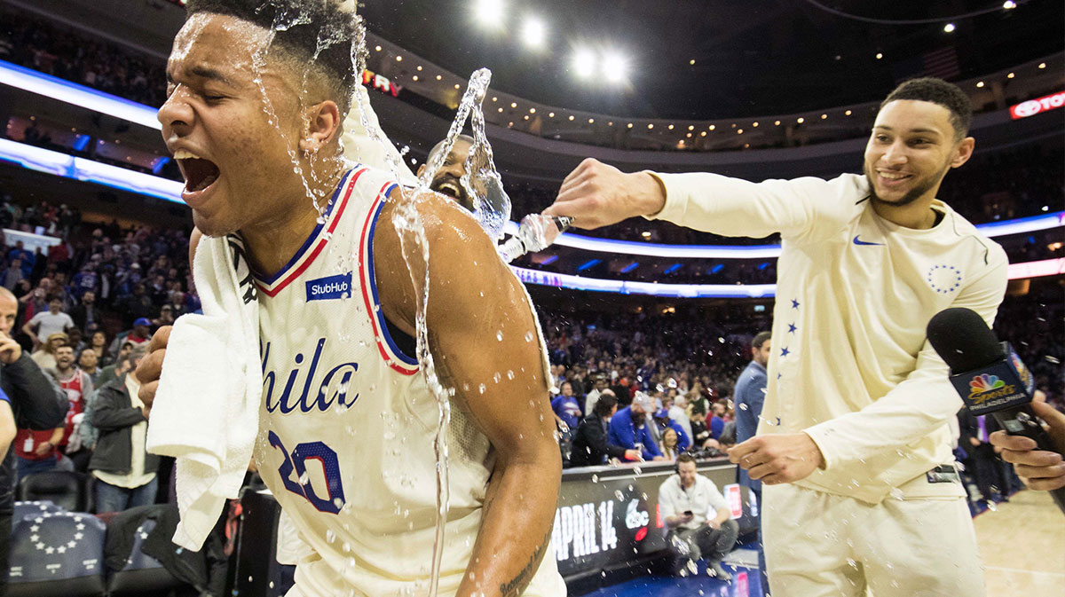 Philadelphia 76ers guard Markelle Fultz (20) is doused with water by guard Ben Simmons (25) and center Amir Johnson (5) after recording his first triple double in a game against the Milwaukee Bucks at Wells Fargo Center.
