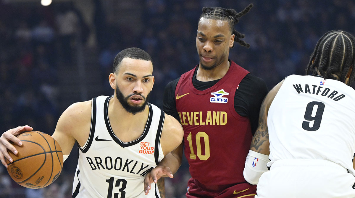 Cleveland Cavaliers guard Darius Garland (10) tries to get between Brooklyn Nets guard Tyrese Martin (13) and forward Trendon Watford (9) in the first quarter at Rocket Arena.