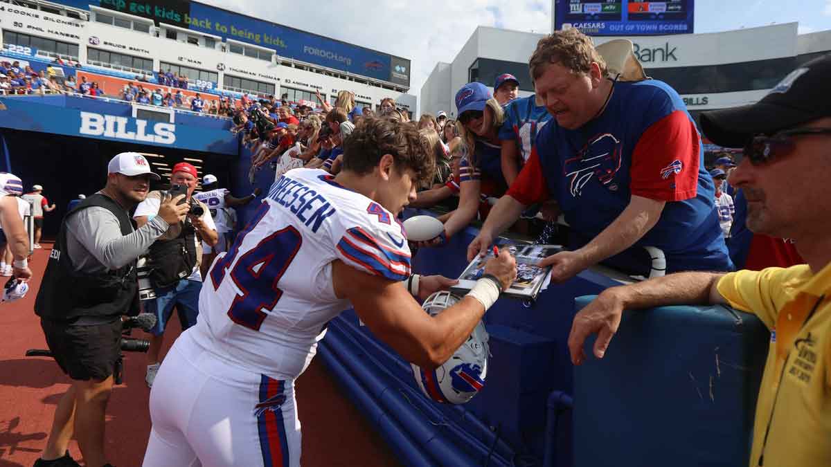 Buffalo Bills linebacker Joe Andreessen gives Harold Fuller of Rochester an autograph as Andreessen heads to the locker room after the preseason game against Carolina Panthers at Highmark Stadium in Orchard Park on Aug. 24, 2024.