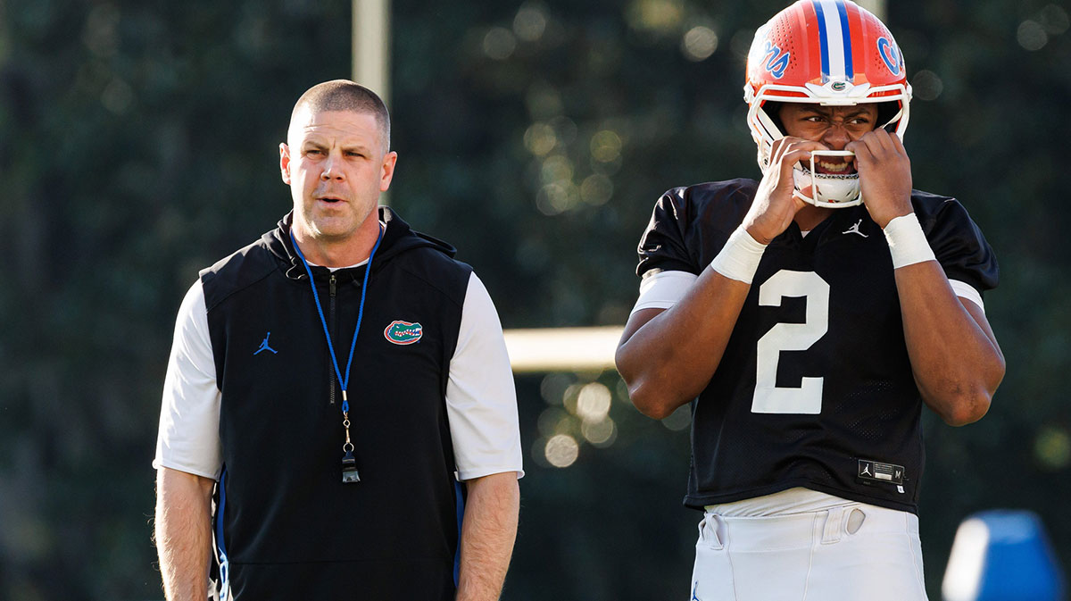 Florida Gators head coach Billy Napier looks on while Florida Gators running back Jadan Baugh (13) walks by before the game at Ben Hill Griffin Stadium.