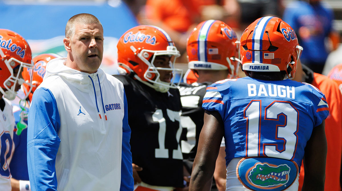 Florida Gators head coach Billy Napier looks on while Florida Gators running back Jadan Baugh (13) walks by before the game at Ben Hill Griffin Stadium.