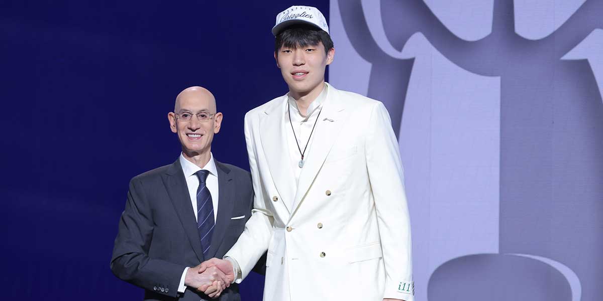 Blazers' Yang Hansen stands with NBA commissioner Adam Silver