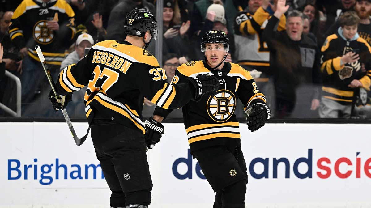 Boston Bruins left wing Brad Marchand (63) celebrates with center Patrice Bergeron (37) after scoring a goal against the Edmonton Oilers during the first period at the TD Garden.