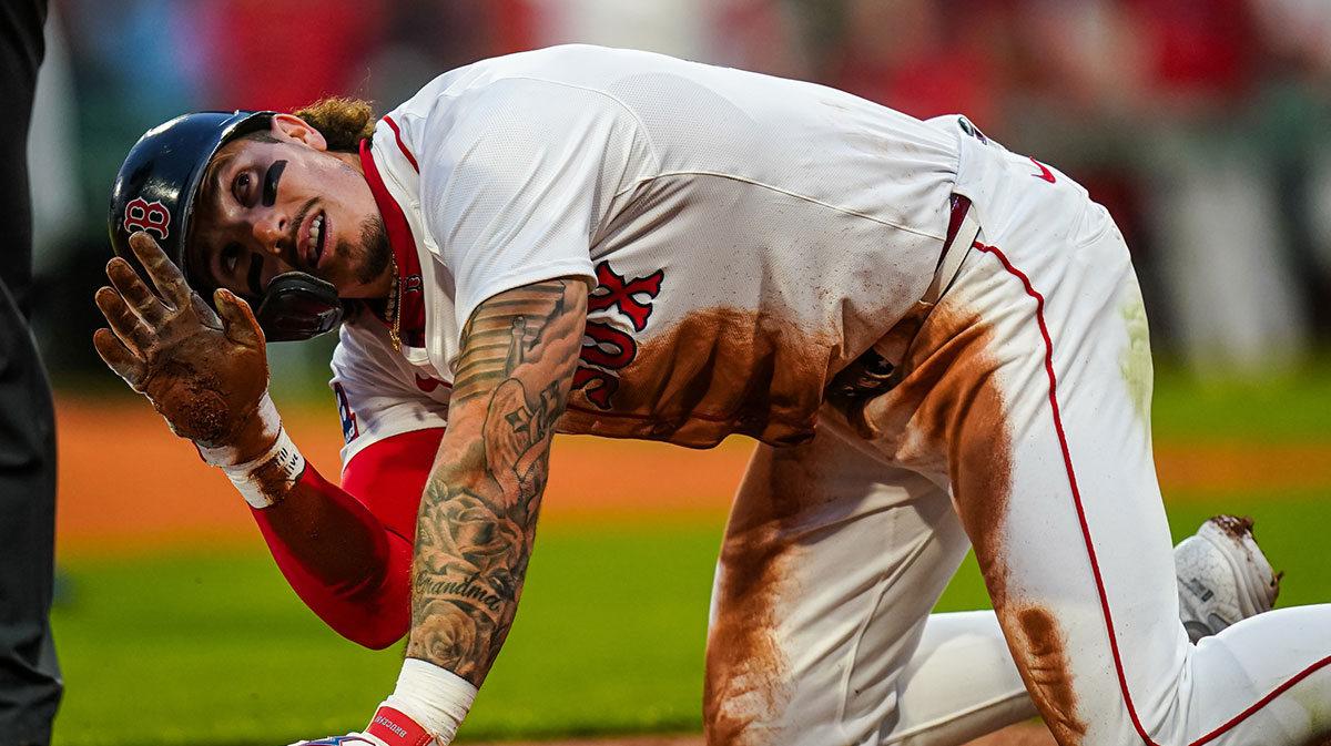 Boston Red Sox outfielder Jarren Duran (16) after sliding into third base against the Tampa Bay Rays in the third inning at Fenway Park.