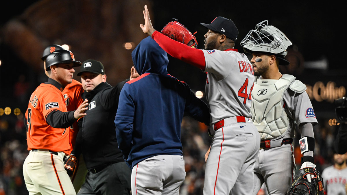 Boston Red Sox pitcher Aroldis Chapman (44) is held back by a staff member after their win over the San Francisco Giants at Oracle Park.