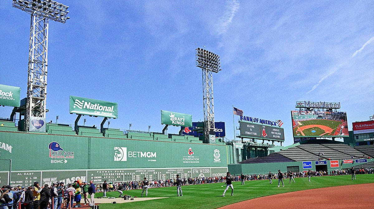 Fans line the field in front of the Green Monster as the Chicago White Sox warm up before a game at Fenway Park.
