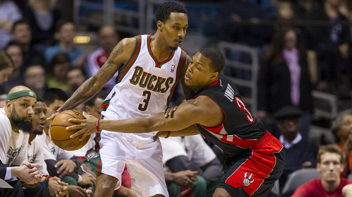 Toronto Raptors guard Kyle Lowry (3) tries to knock the ball away from Milwaukee Bucks guard Brandon Jennings (3) during the first quarter at the BMO Harris Bradley Center.