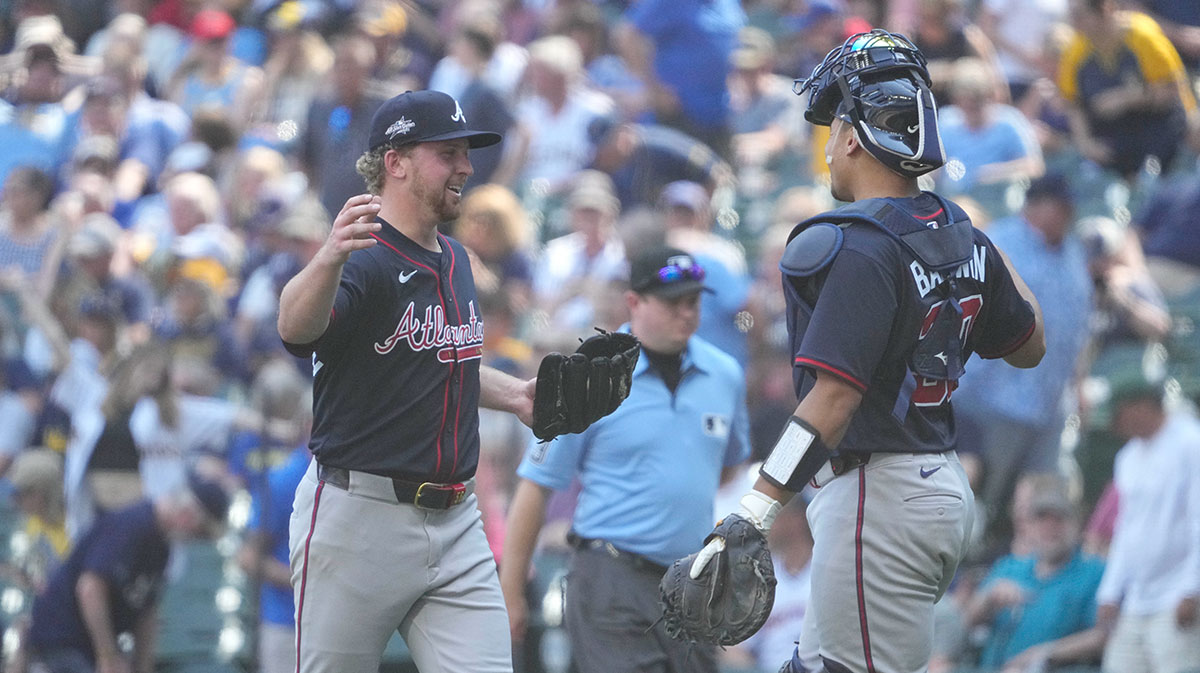 Atlanta Braves pitcher Spencer Schwellenbach (56) celebrates with catcher Drake Baldwin (30) after pitching a complete game against the Milwaukee Brewers at American Family Field.
