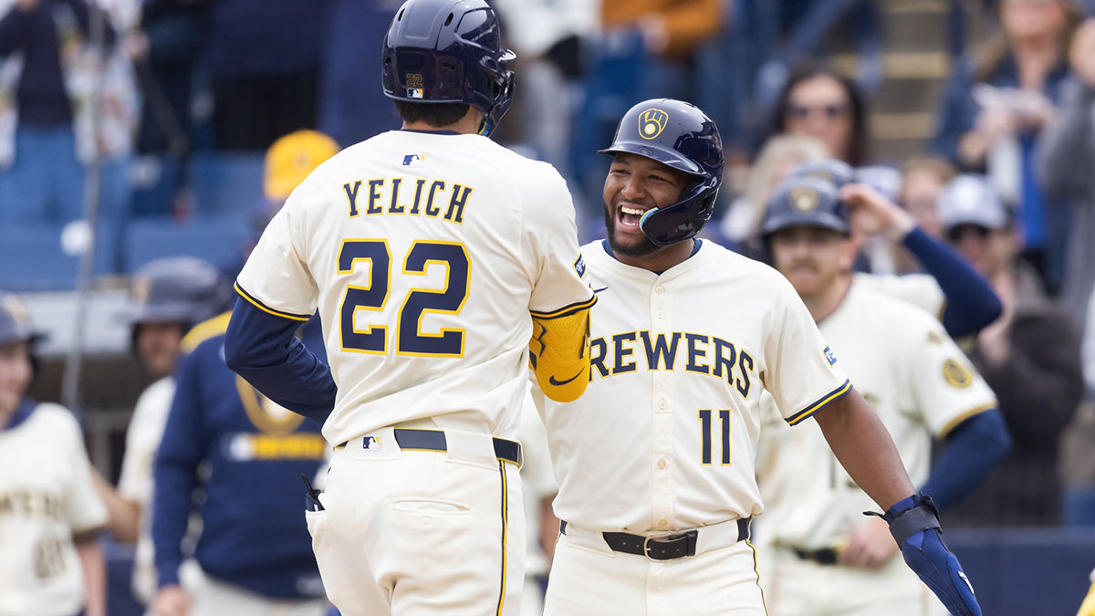 Mar 14, 2025; Phoenix, Arizona, USA; Milwaukee Brewers designated hitter Christian Yelich (22) celebrates with outfielder Jackson Chourio after hitting a home run against the San Francisco Giants during a spring training game at American Family Fields of Phoenix. Mandatory Credit: Mark J. Rebilas-Imagn Images