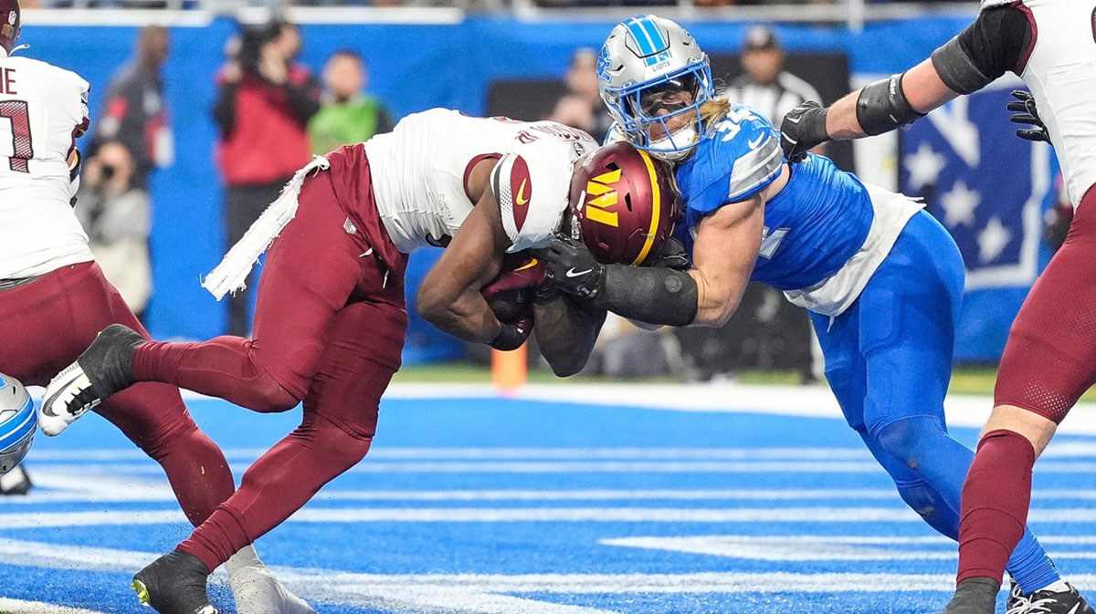 Washington Commanders running back Brian Robinson Jr. (8) runs for a touchdown against Detroit Lions linebacker Alex Anzalone (34) during the first half of the NFC divisional round.