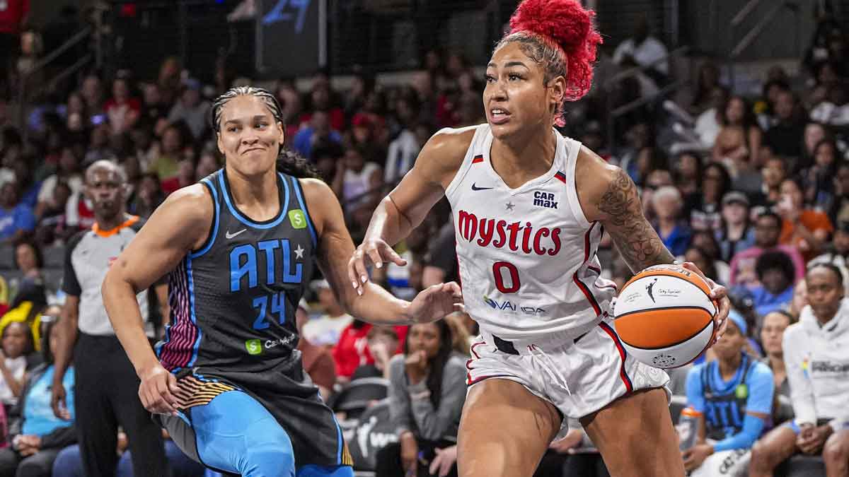 Jun 20, 2025; College Park, Georgia, USA; Washington Mystics forward Shakira Austin (0) dribbles past Atlanta Dream forward Brionna Jones (24) during the first half at Gateway Center Arena at College Park. Mandatory Credit: Dale Zanine-Imagn Images