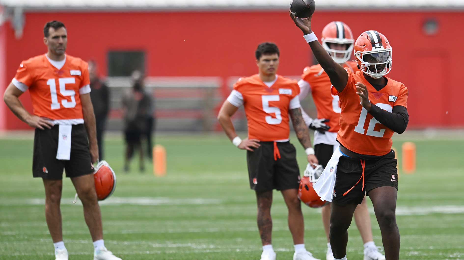 Cleveland Browns quarterback Shedeur Sanders (12) throws a pass as quarterback Joe Flacco (15) and quarterback Dillon Gabriel (5) and quarterback Kenny Pickett (8) look on during minicamp at CrossCountry Mortgage Campus.