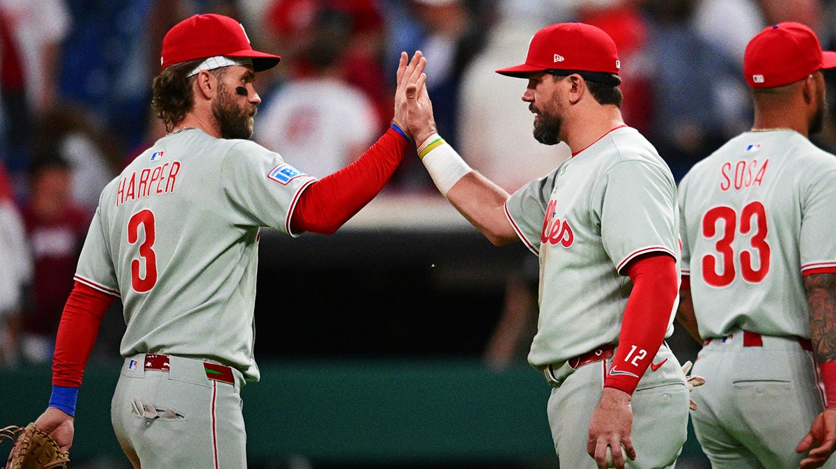 Philadelphia Phillies designated hitter Kyle Schwarber (12) celebrates with first baseman Bryce Harper (3) after the Phillies beat the Cleveland Guardians at Progressive Field.