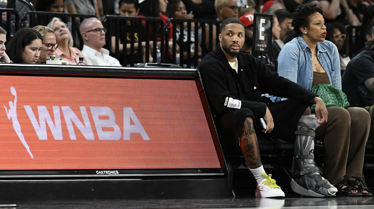 Bucks' Damian Lillard sits courtside