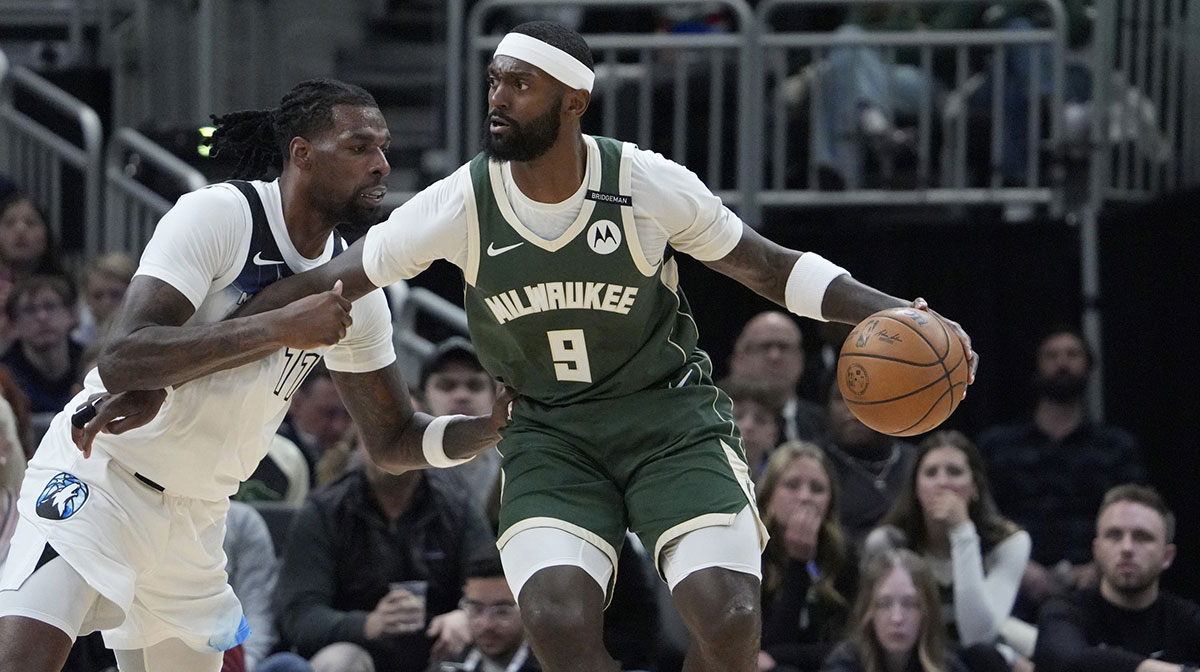 Milwaukee Bucks forward Bobby Portis (9) drives against Minnesota Timberwolves center Naz Reid (11) in the first half at Fiserv Forum.
