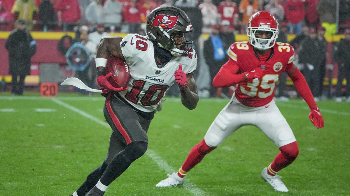 Tampa Bay Buccaneers wide receiver Trey Palmer (10) runs the ball as Kansas City Chiefs cornerback Keith Taylor Jr. (39) defends during the game at GEHA Field at Arrowhead Stadium.