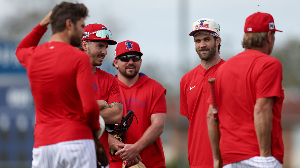 Philadelphia Phillies shortstop Trea Turner (7) (left) second base Bryson Stott (5) (left center) second base Buddy Kennedy (19) (center) first base Bryce Harper (3) (right) participate in spring training workouts at BayCare Ballpark.