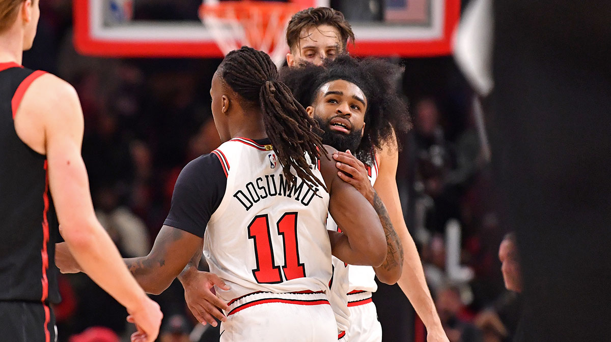 Chicago Bulls guard Coby White (behind) hugs guard Ayo Dosunmu (11) during overtime against the Toronto Raptors at the United Center.